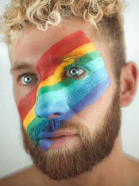 LGBT flag painted on a face