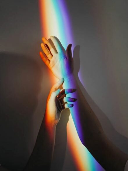 hands with a rainbow