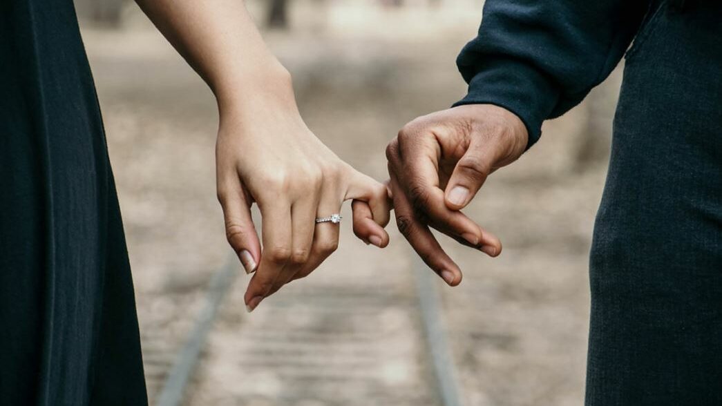two hands hold each other