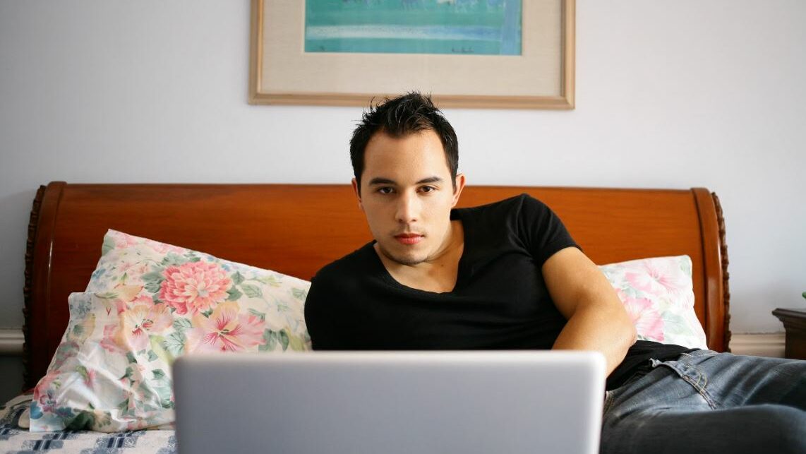 a guy front of a laptop