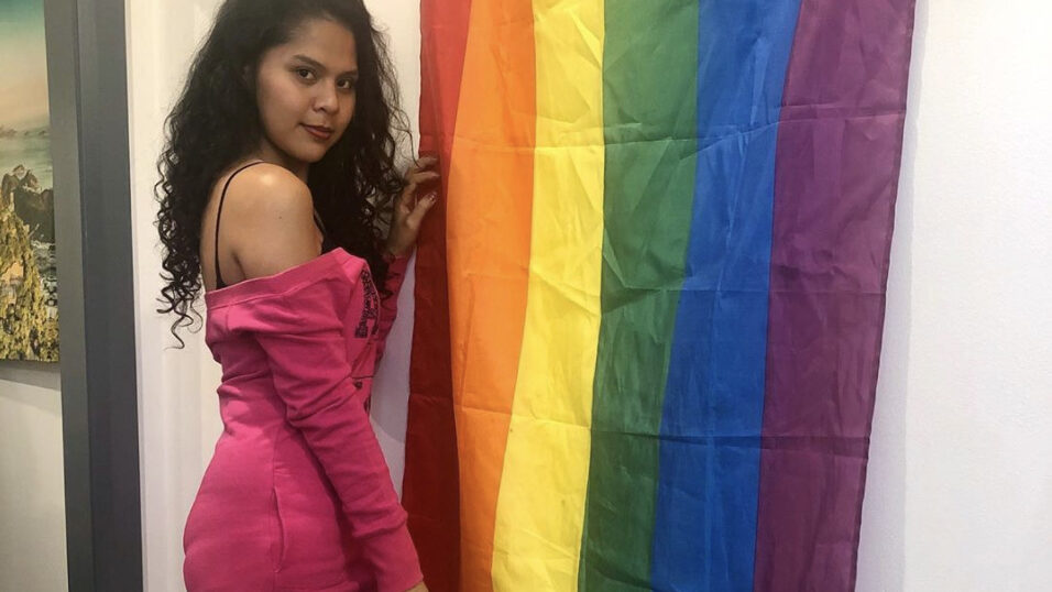 Destiny Maylas with an LGBT flag