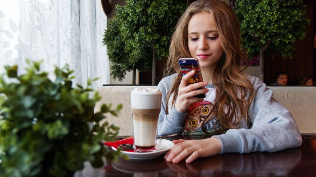 a trans woman typing on her smartphone