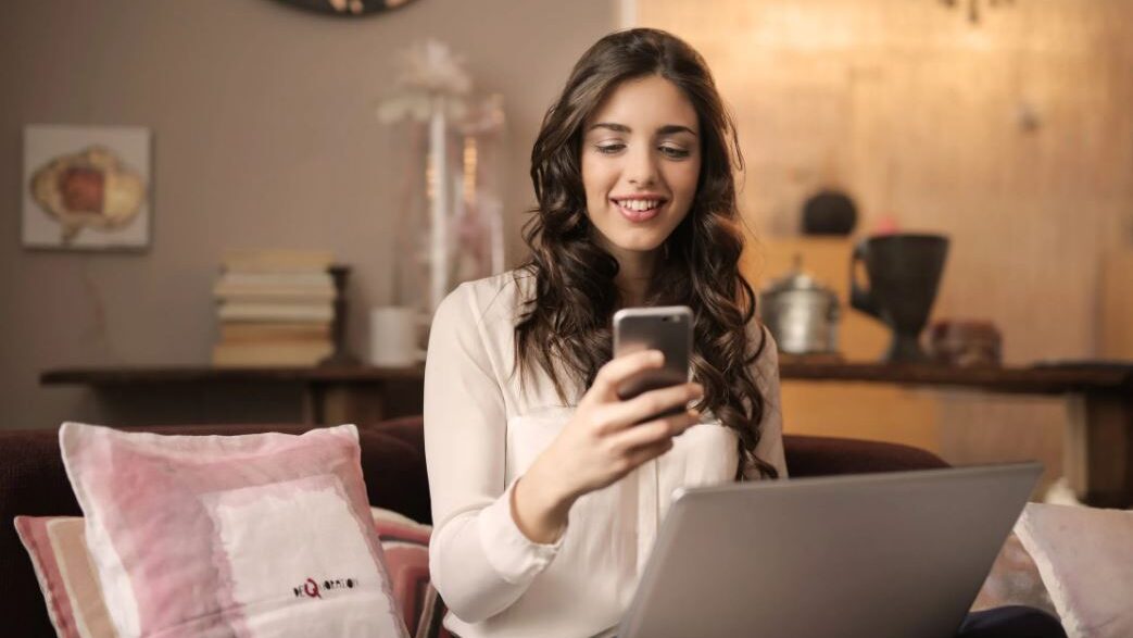 a transgender woman typing on her smartphone