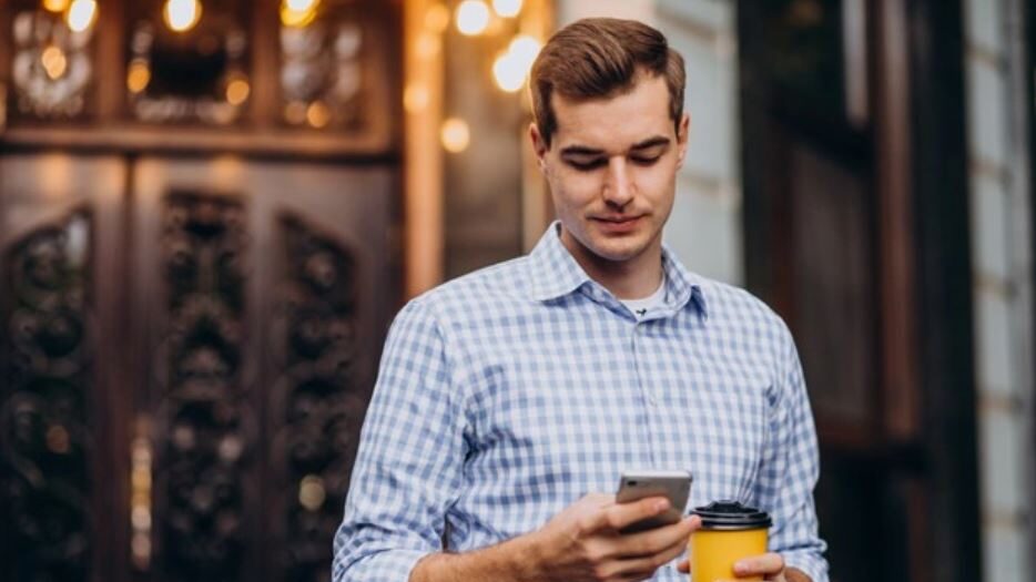 a man typing on a smartphone