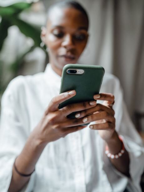 a woman tapping on a smartphone