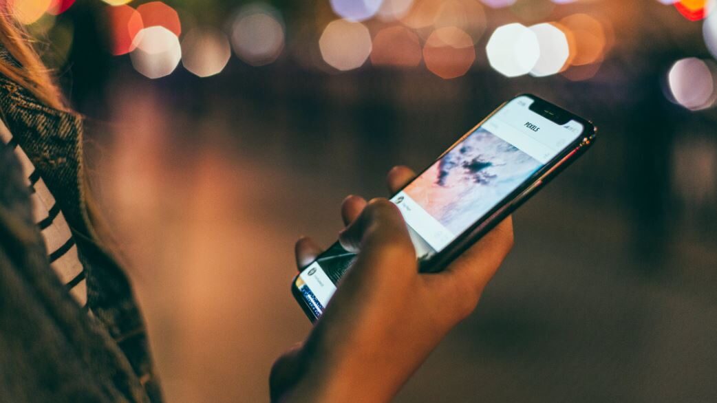 person typing on a smartphone