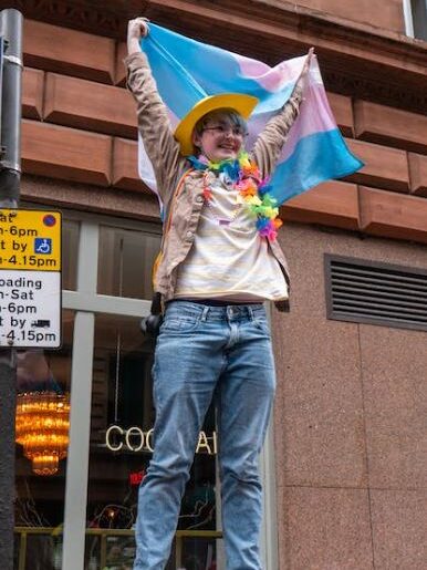 a trans woman with a flag