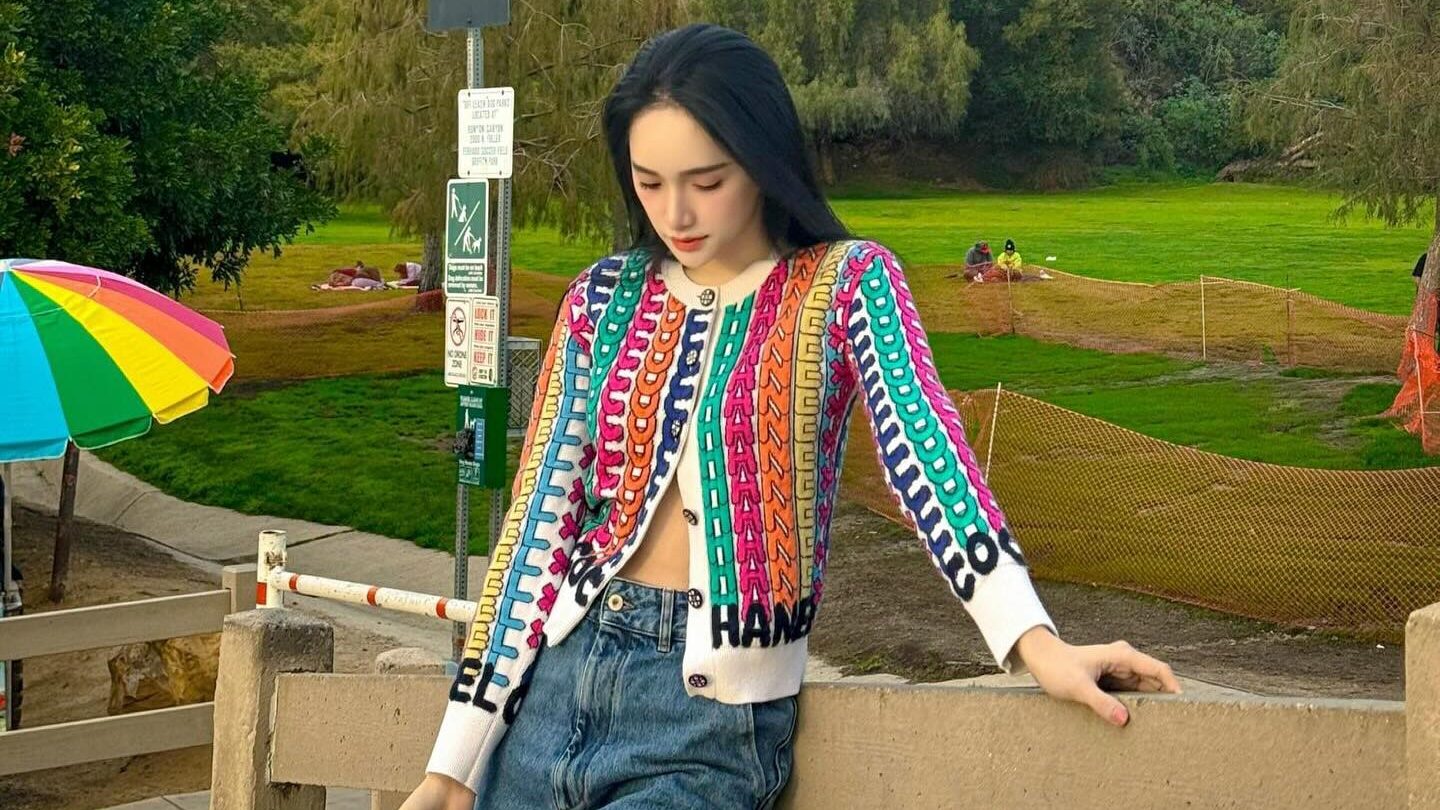 Nguyen Huong Giang wearing a colorful patterned cardigan and jeans, exuding a casual and stylish vibe. Image from Instagram @huoggiangggg