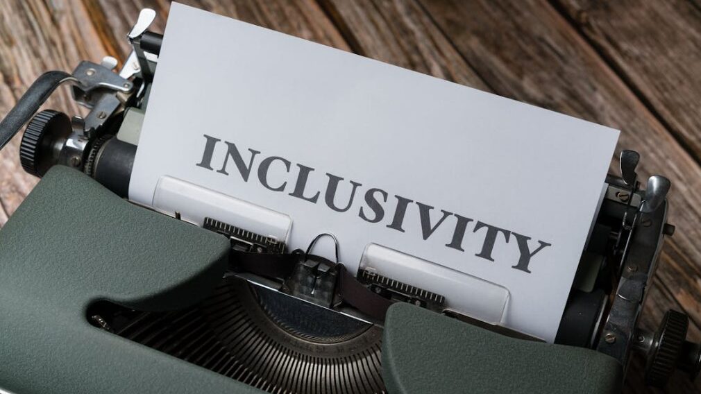 Vintage typewriter with a sheet of paper showing the word 'INCLUSIVITY'.