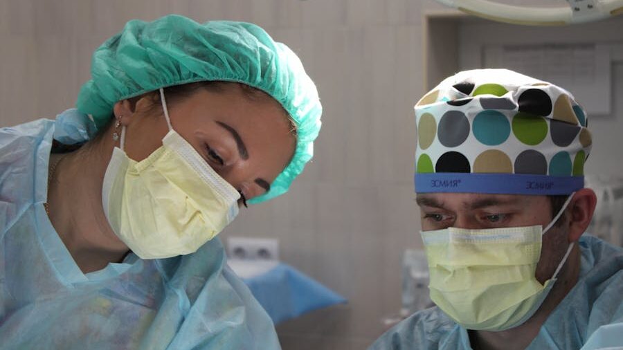 Surgical team focused on performing surgery under bright lights in an operating room.