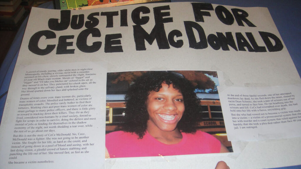 A handmade poster with bold black text reading 'Justice for CeCe McDonald' and a smiling photo of CeCe McDonald. The poster contains printed text detailing her story and call for justice.