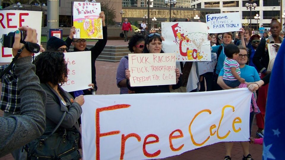 A diverse group of protesters holding signs and banners advocating for justice and freedom for CeCe McDonald.