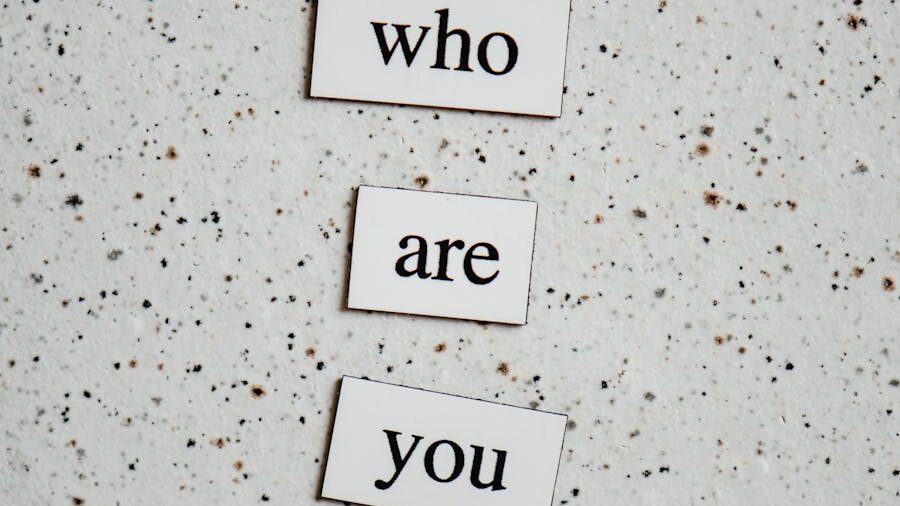 Magnetic word tiles arranged on a speckled surface, forming the phrase "who are you."