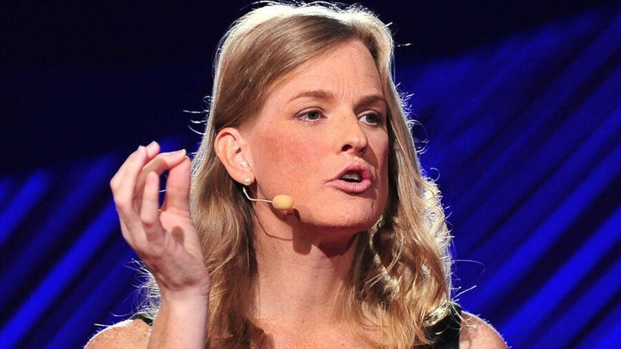 Dr. Vivienne Ming speaking on stage at TEDmed 2015, wearing a black and blue dress with a headset mic.