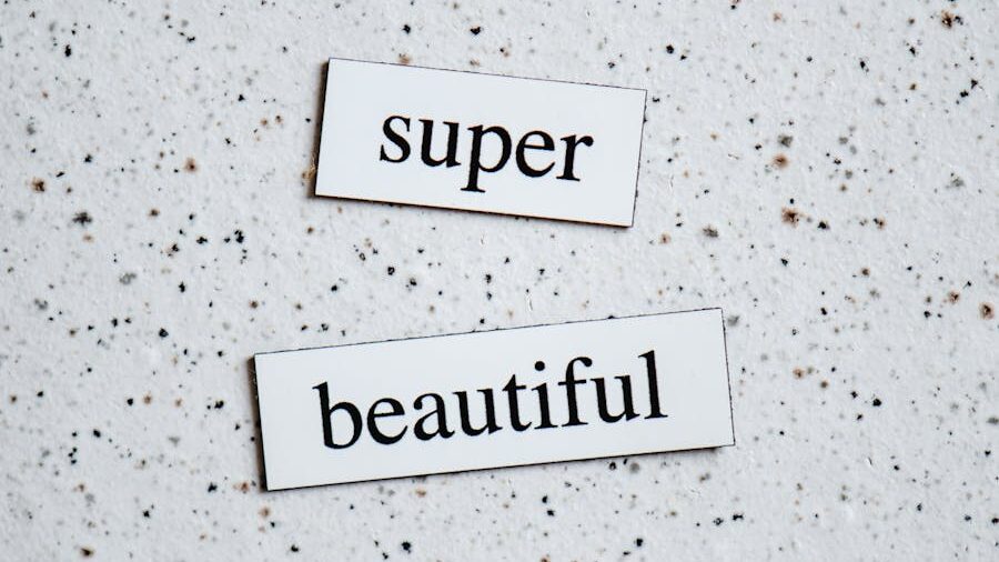Two paper strips placed on a white speckled surface with the words “super” and “beautiful” in black serif font.