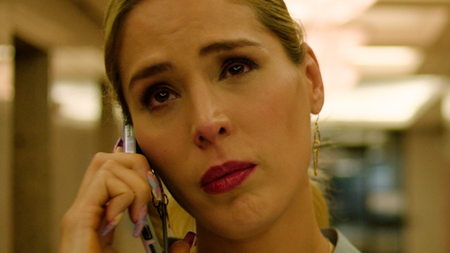 Carmen Carrera holding a phone during an emotional scene in the film TransLosAngeles, filmed indoors with soft lighting.