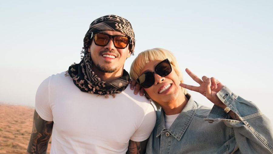 Vice Ganda and Ion Perez posing together in desert landscape wearing casual clothes and sunglasses.