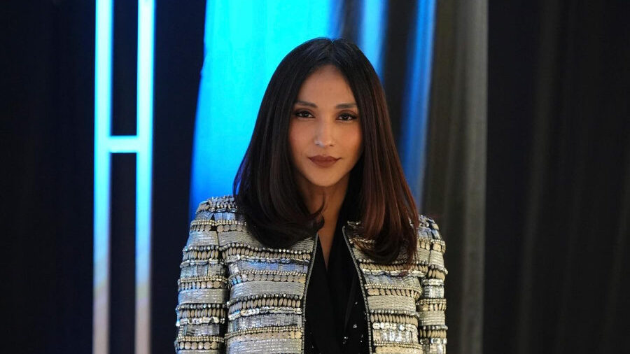Dena Rachman attends Plaza Indonesia Fashion Week wearing a textured jacket and black leather-look trousers.