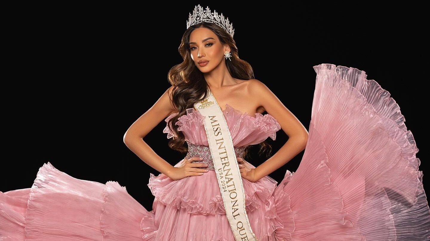 Kataluna Enriquez wears a flowing pink evening gown, crown and Miss International Queen USA sash during a studio photoshoot in Las Vegas in 2023.