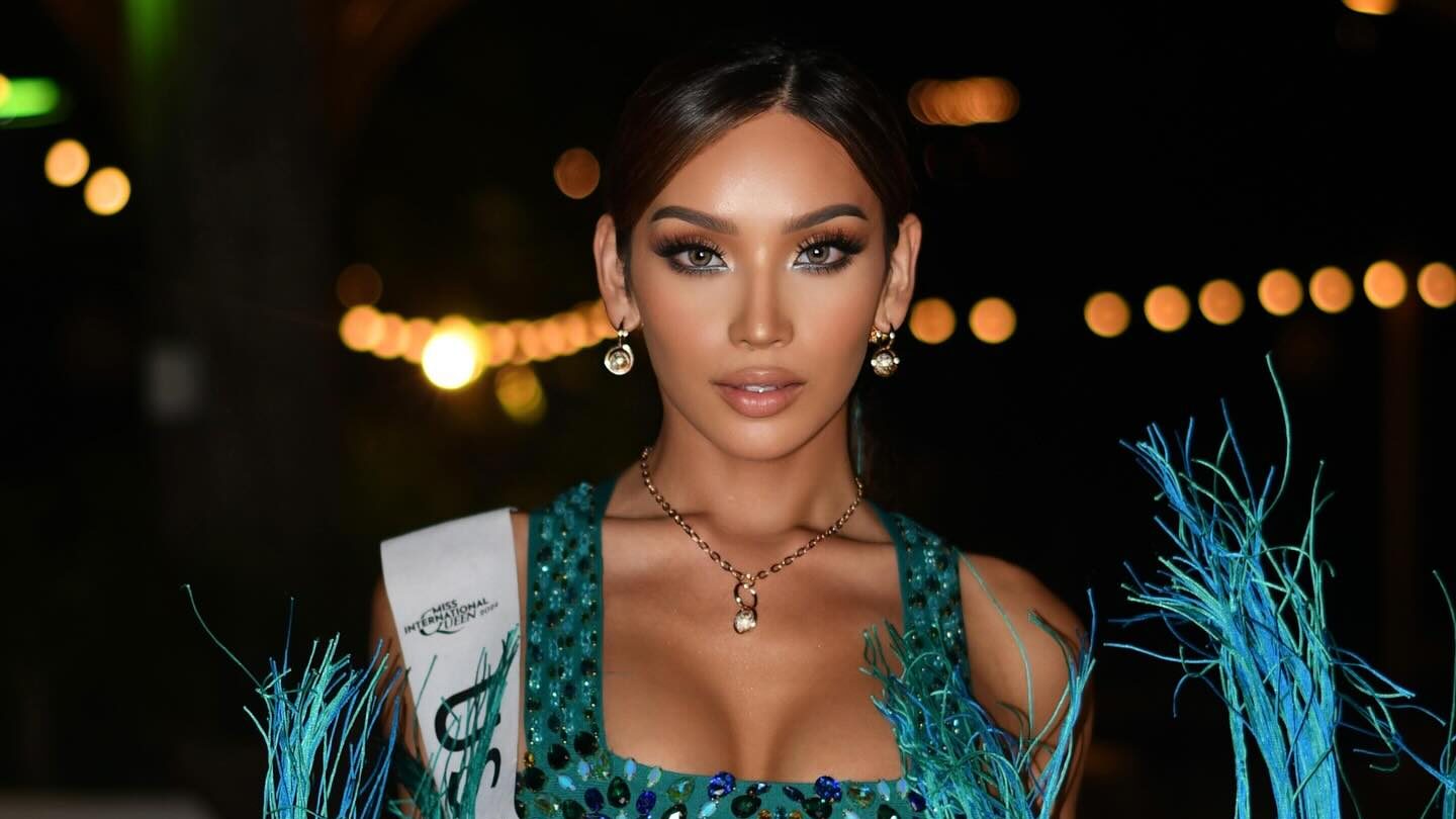Kataluna Enriquez wears a sparkling turquoise pageant outfit with a white sash during Miss International Queen 2024 in Pattaya, Thailand.