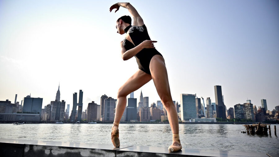 Sabrina Pretto balancing on pointe during an outdoor ballet photoshoot overlooking Manhattan in New York City.